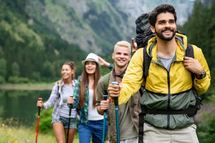 Team working together on a hike/scavenger hunt in by green mountains