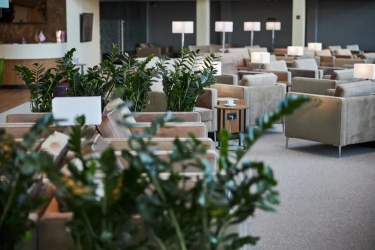 A comfortable lounge area at an event with plush seating and charging stations.