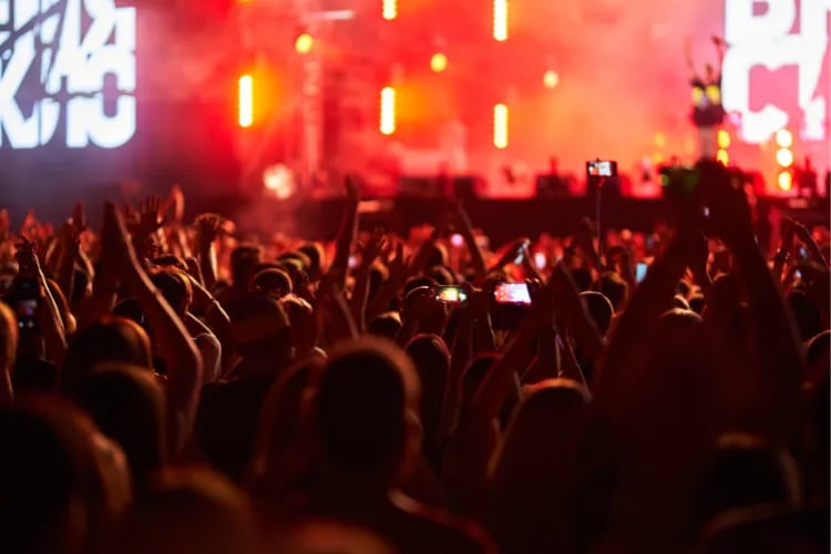 Crowd at an outdoor festival everyone standing next to each other. With massive amount of people, the event risk increases significantly
