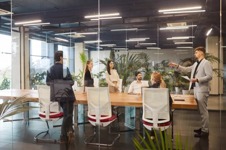 Event planning team reviewing floor plans and transportation schedules