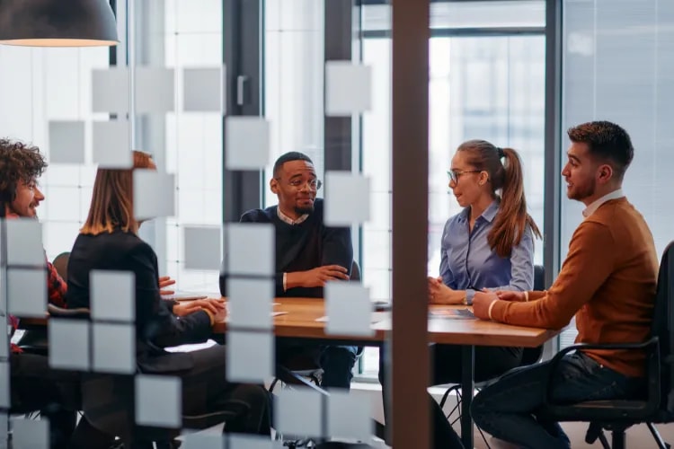 An event team meeting and discussing their upcoming event schedule and project management details