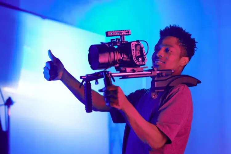 A photographer adjusting camera settings before an event to dial in exposure and focus.