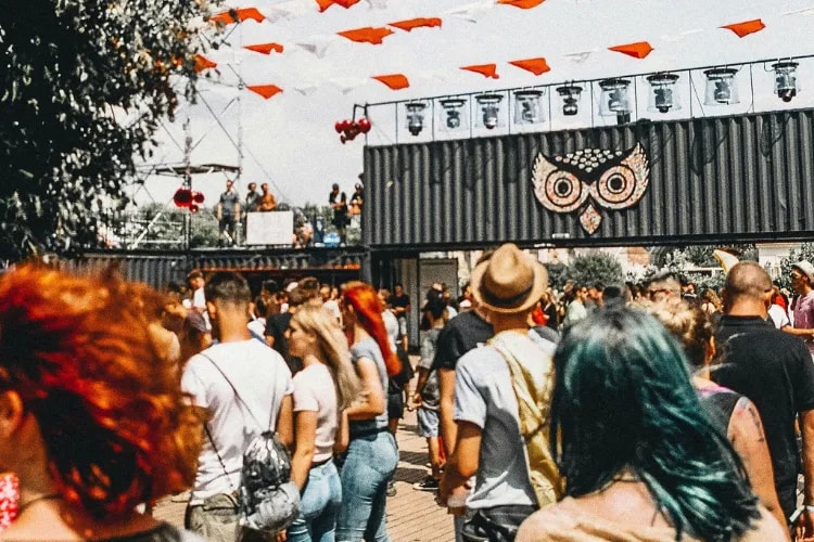 A diverse crowd enjoying a free, open-to-all community event—smiles, conversations, and inclusive vibes.