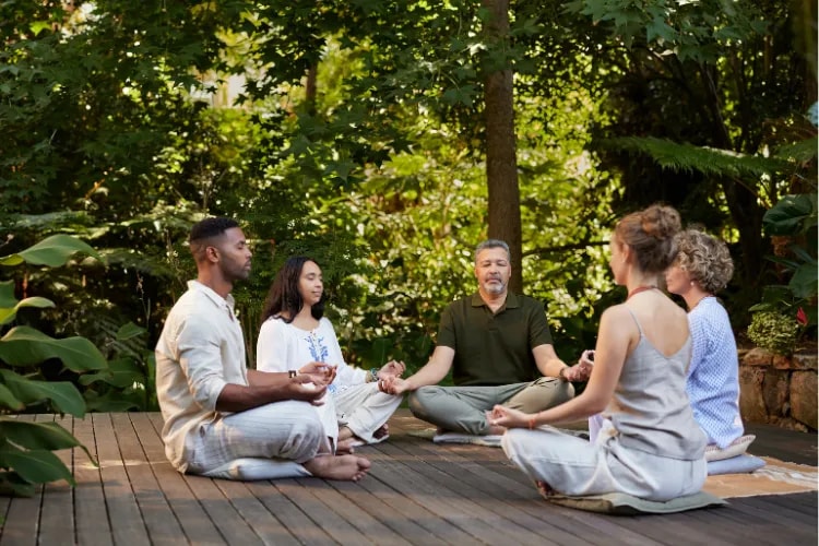A group of people participating in a mindfulness workshop, practicing meditation techniques.