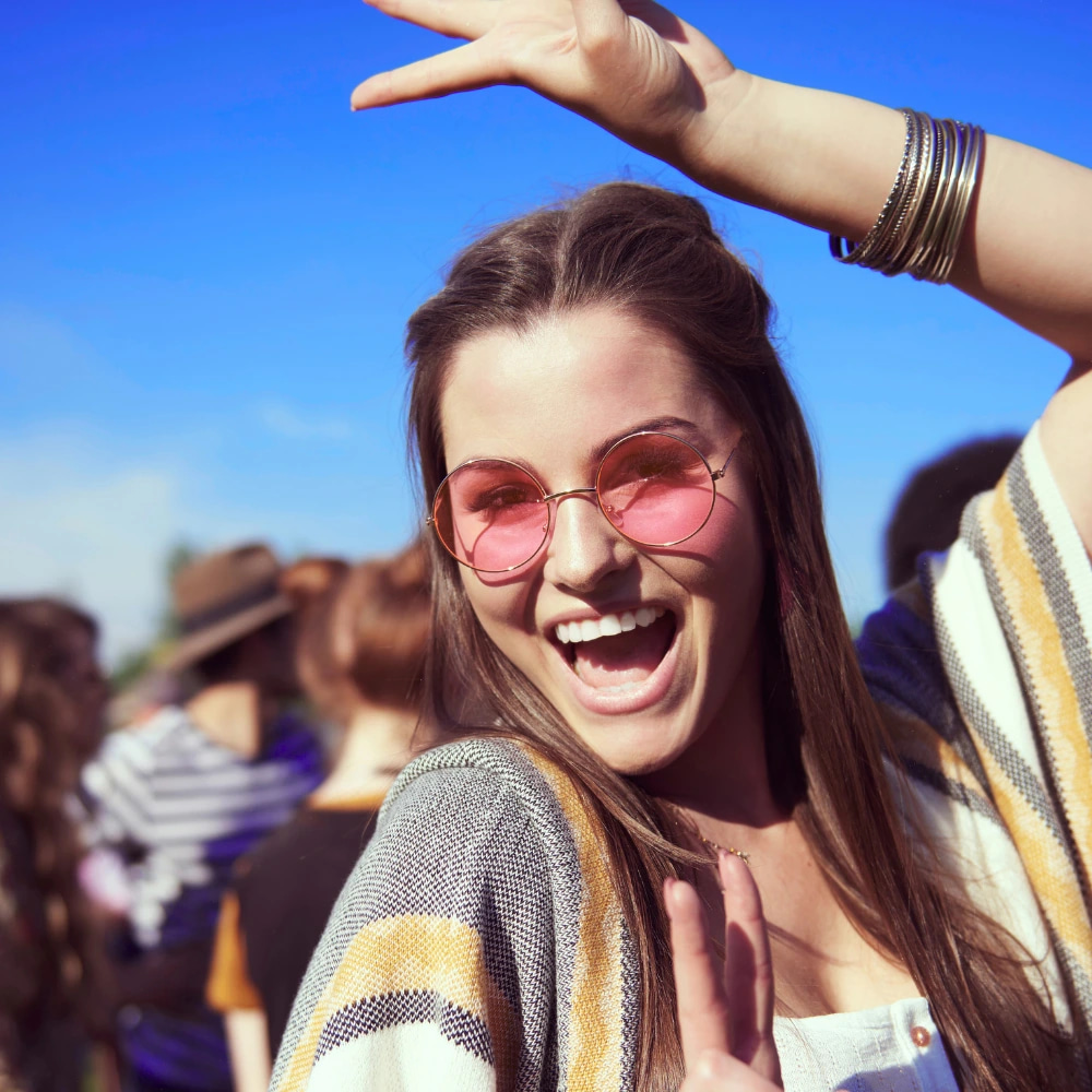 An event attendee, young woman at a festival. Highlighting the of proper event marketing tools to reach the right people.